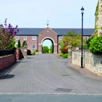 New Hall Court, Northfields, Bickerton Courtyard with large Arch leading to fields